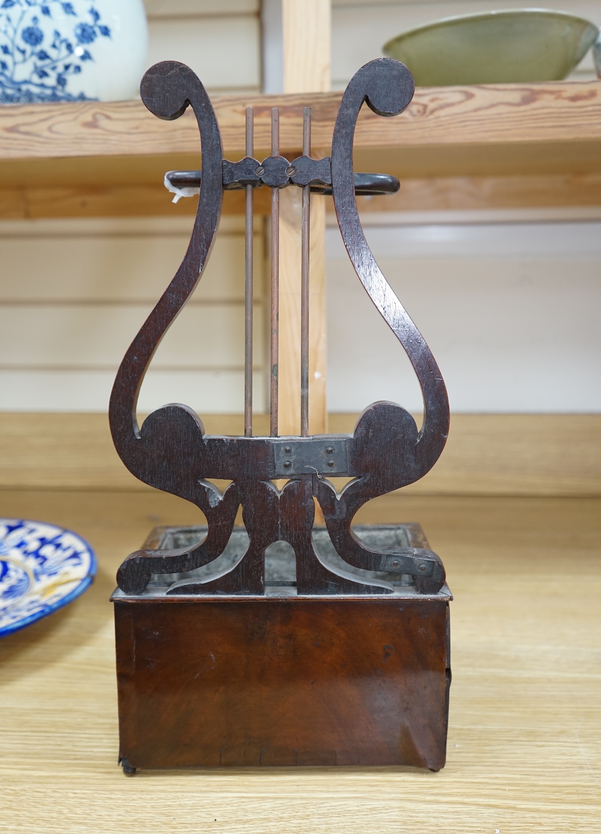 A rare Regency mahogany clay pipe stand, the lyre shaped back over a tobacco draw, 45cm tall. Condition - poor